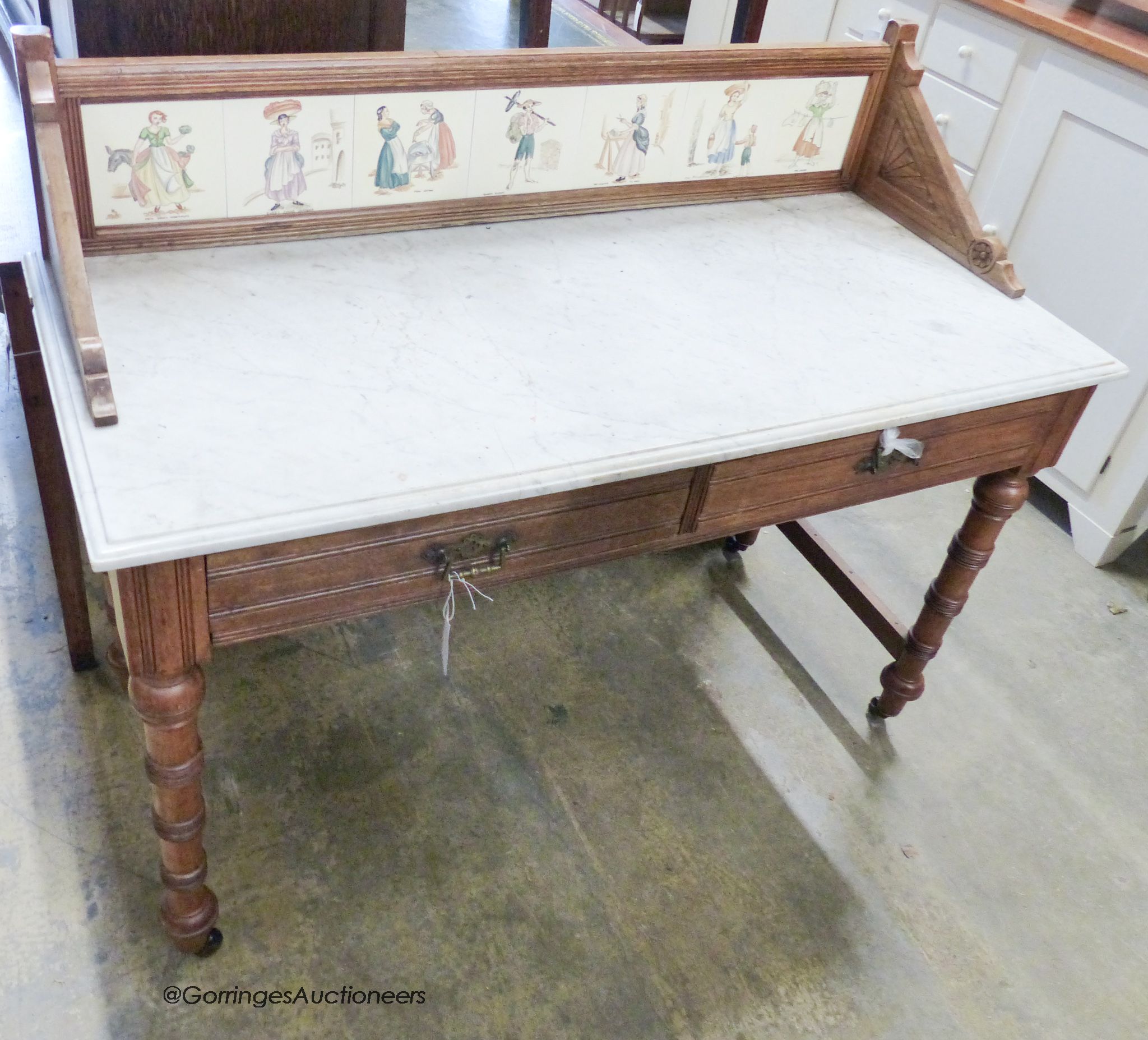 A Victorian walnut marble top tile back washstand. W-122, D-54, H-99.